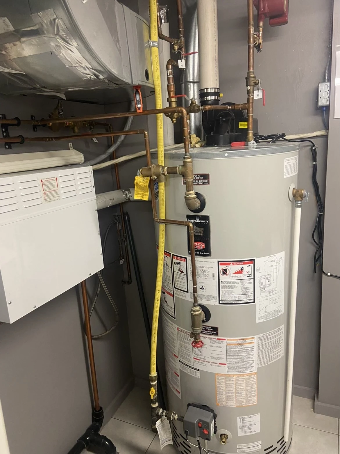 Storage water heater and connected piping